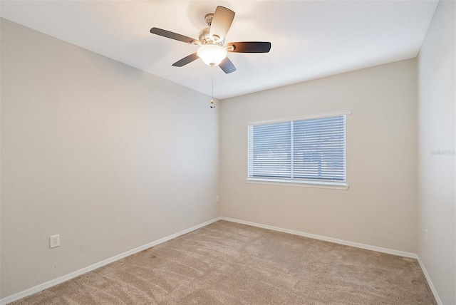 carpeted spare room with ceiling fan