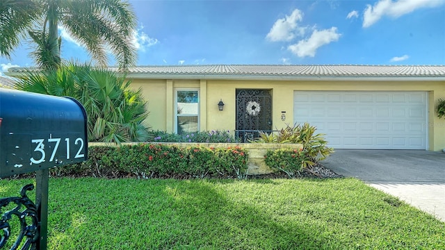 view of front of home with a garage and a front yard