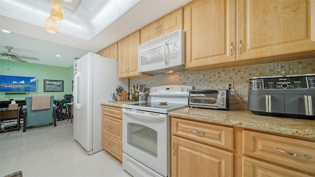 kitchen with light tile patterned floors, light brown cabinets, light stone countertops, decorative backsplash, and white appliances