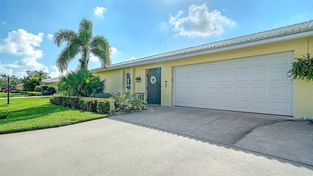 3712 Hampshire Ln Unit 5623, Sarasota, FL 34232 - ranch-style house with concrete driveway, a front lawn, stucco siding, and an attached garage
