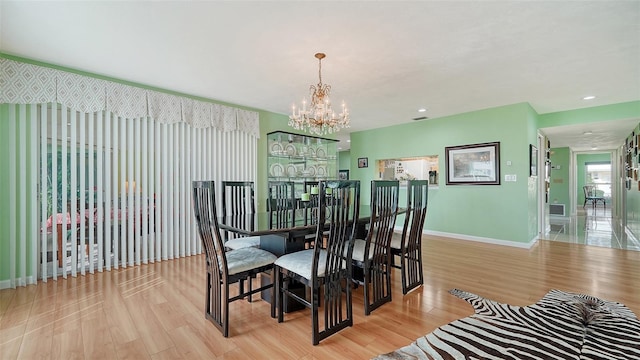 dining room featuring light hardwood / wood-style floors and a notable chandelier