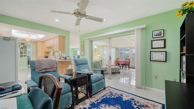 sitting room with ceiling fan and light tile patterned floors