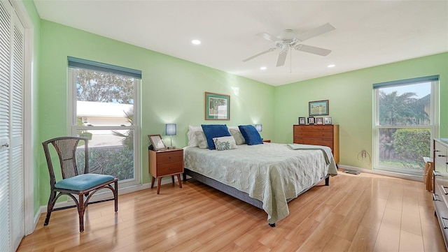 bedroom featuring a closet, light wood-type flooring, and ceiling fan