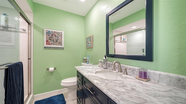 bathroom with toilet, vanity, tile patterned floors, and a shower with shower door