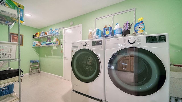 clothes washing area with separate washer and dryer