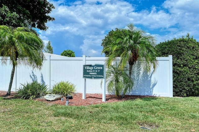 community sign featuring a lawn