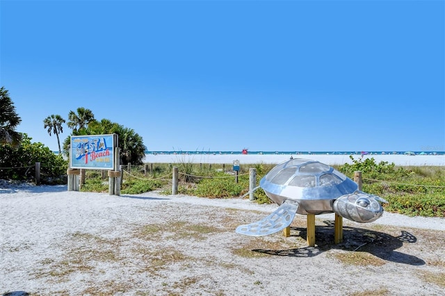 exterior space featuring a water view and a beach view