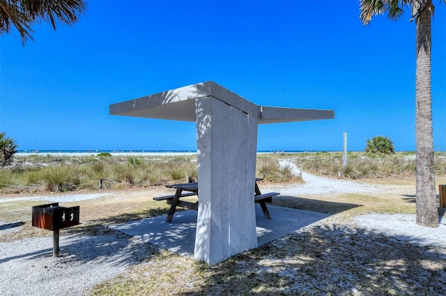 view of community featuring a water view and a beach view