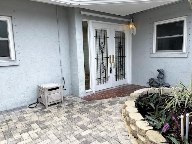 doorway to property with a patio area and french doors