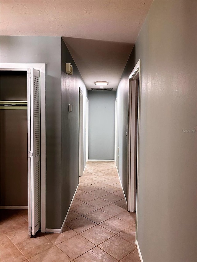 hall featuring light tile patterned floors