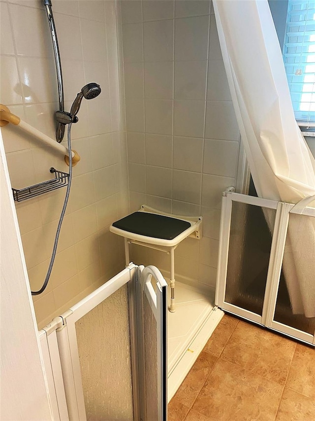 bathroom with tile patterned flooring and tile walls