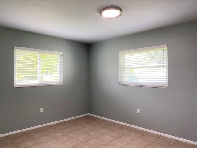 spare room with light tile patterned flooring