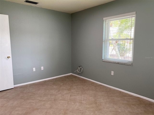 spare room with light tile patterned floors