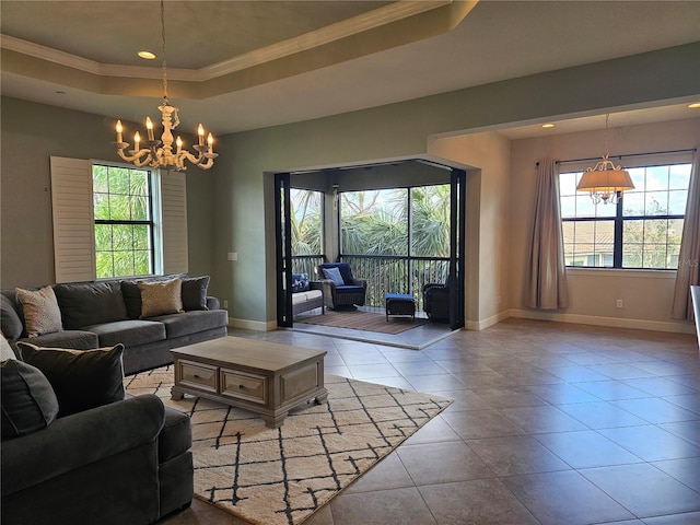 living room with light tile patterned floors, a raised ceiling, crown molding, and an inviting chandelier