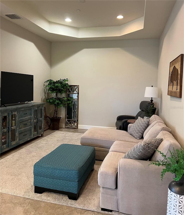 living room featuring a raised ceiling