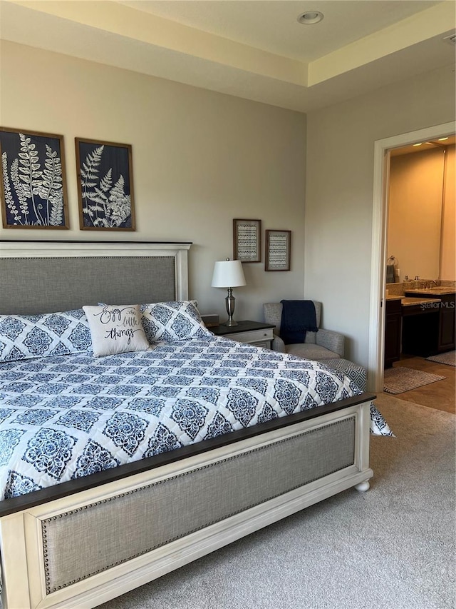 carpeted bedroom featuring connected bathroom