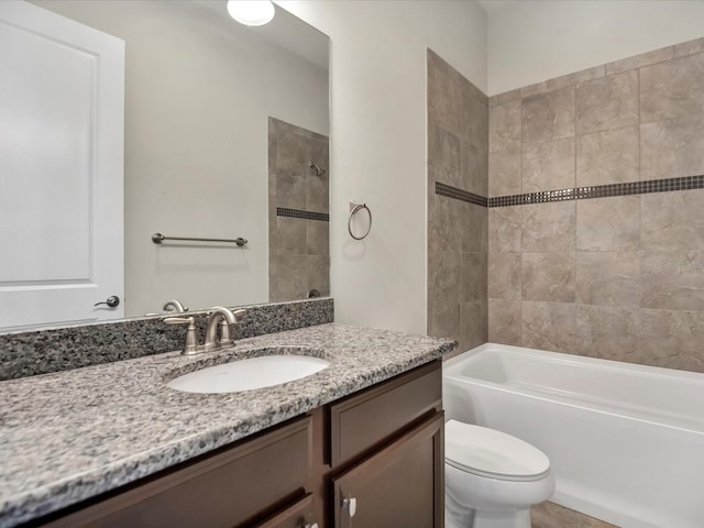 full bathroom featuring vanity, toilet, and tiled shower / bath