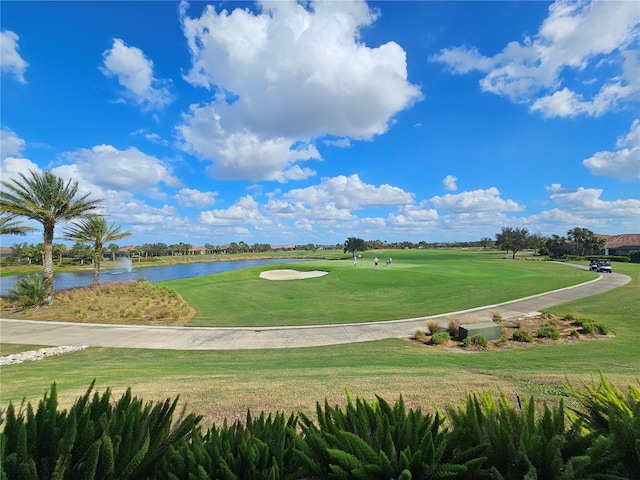 surrounding community featuring a lawn and a water view