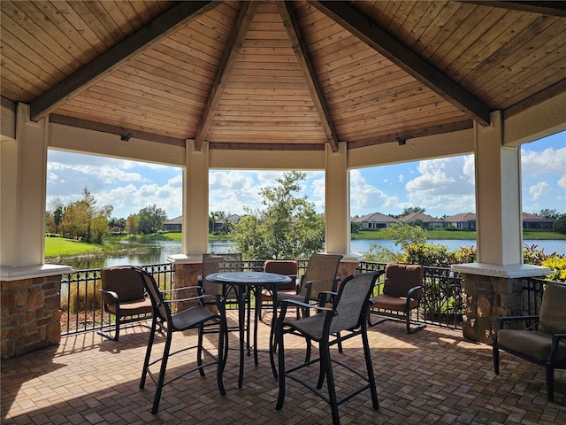 view of patio with a gazebo and a water view