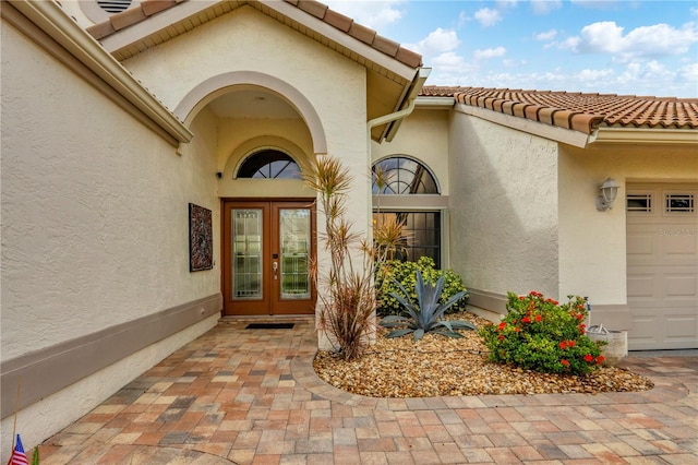 doorway to property with french doors and a garage