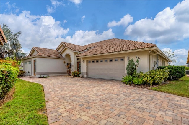 mediterranean / spanish house featuring a garage