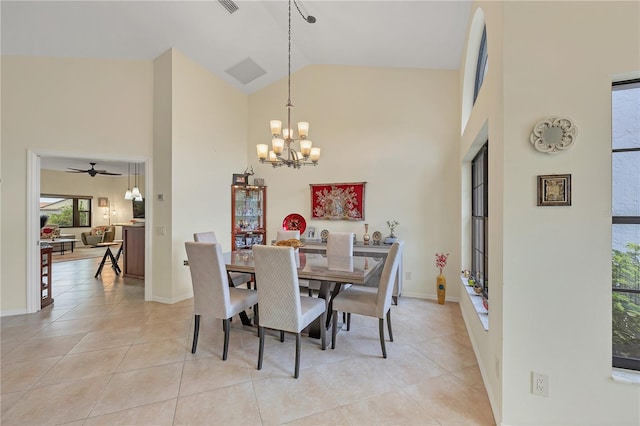 dining room featuring high vaulted ceiling, light tile patterned floors, and ceiling fan with notable chandelier