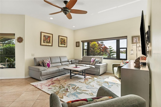 living room with ceiling fan, light tile patterned flooring, and plenty of natural light