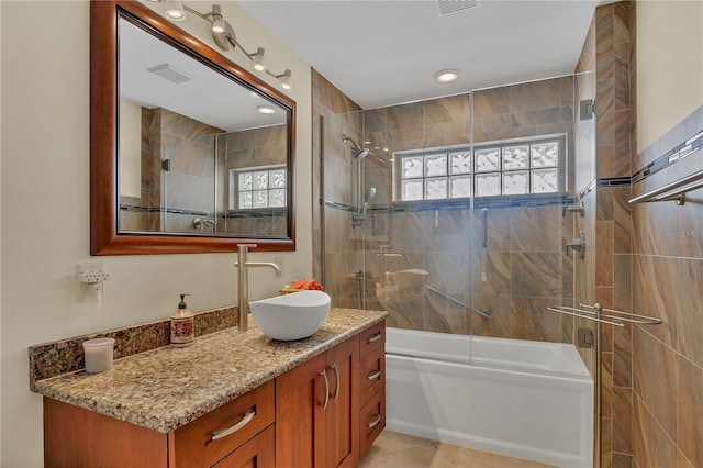 bathroom featuring vanity, tile patterned floors, and enclosed tub / shower combo