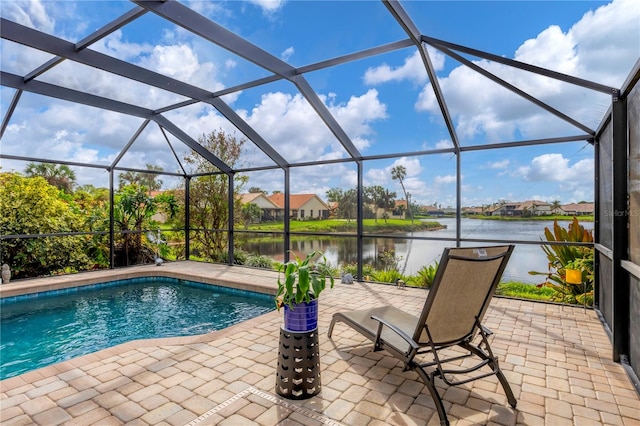 view of swimming pool featuring a water view, glass enclosure, and a patio area