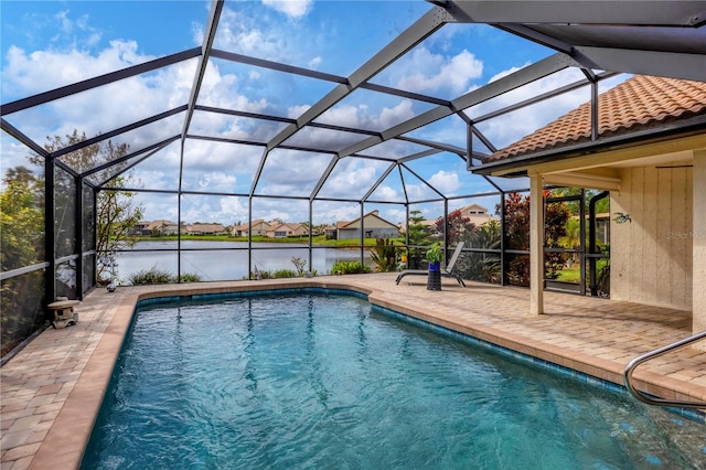 view of pool featuring a patio, a water view, and a lanai