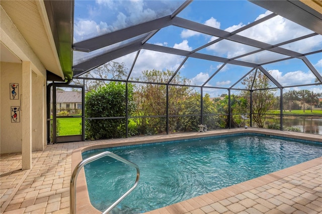 view of pool featuring a lanai, a water view, and a patio area