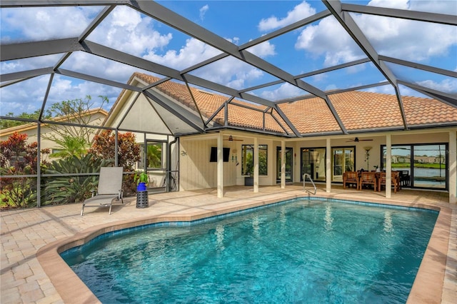 view of swimming pool with ceiling fan, a lanai, and a patio area