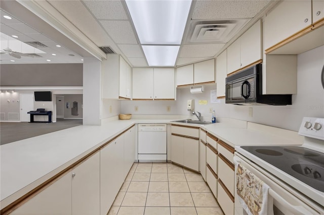 kitchen with white cabinets, sink, and white appliances