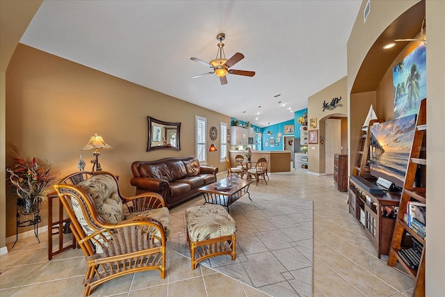 living room with light tile patterned flooring, ceiling fan, and lofted ceiling