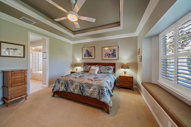 bedroom with light carpet, ornamental molding, ensuite bathroom, ceiling fan, and a raised ceiling