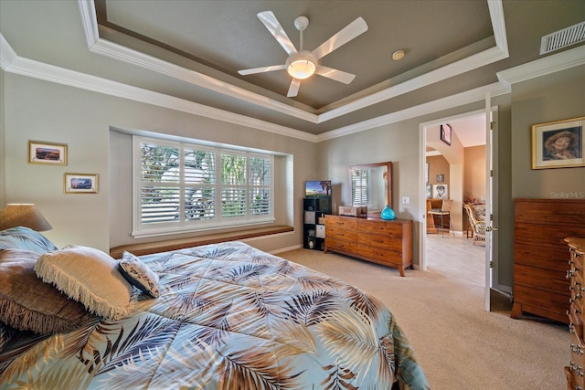 bedroom with light carpet, ceiling fan, crown molding, and a tray ceiling