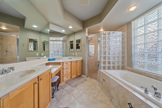 bathroom with vanity, plus walk in shower, and tile patterned flooring