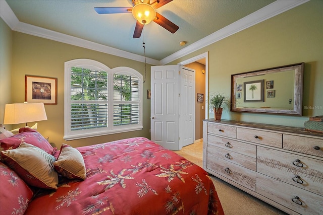 bedroom with ceiling fan, a textured ceiling, crown molding, and light colored carpet