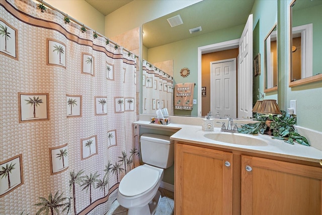 bathroom featuring curtained shower, tile patterned flooring, vanity, and toilet