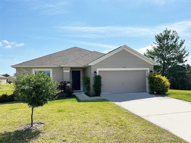 ranch-style house featuring a front yard and a garage