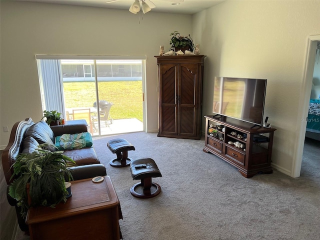 carpeted living room with ceiling fan