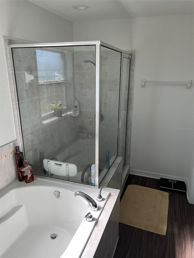 bathroom featuring hardwood / wood-style floors and separate shower and tub