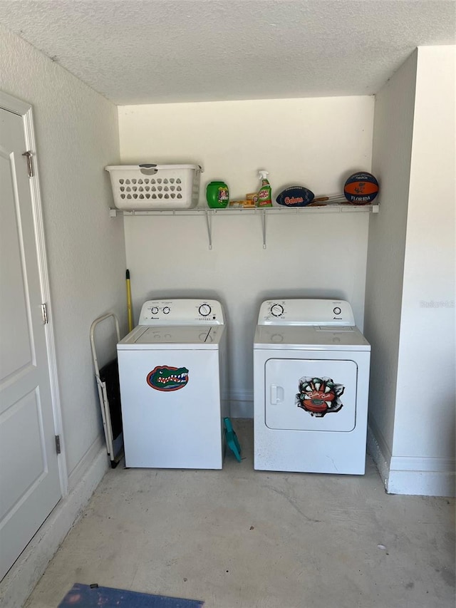 laundry area featuring a textured ceiling and separate washer and dryer