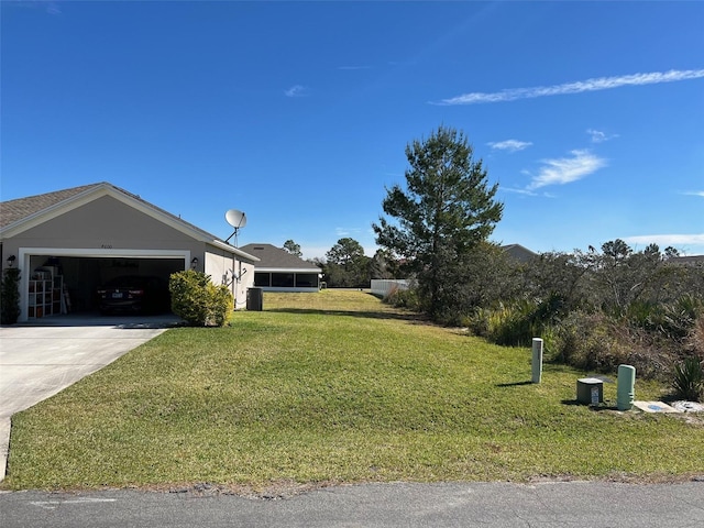 exterior space with a garage, central air condition unit, and a front lawn