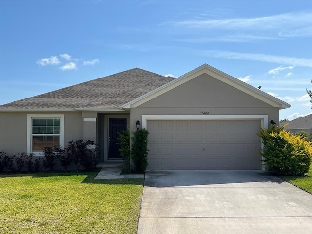 ranch-style home featuring a garage and a front lawn