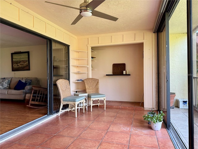 interior space with ceiling fan