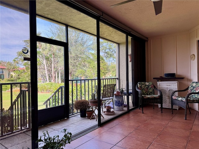 sunroom with plenty of natural light and ceiling fan