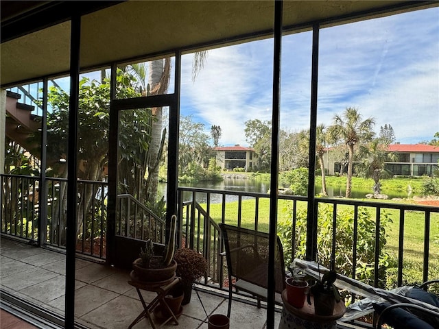 unfurnished sunroom with a water view