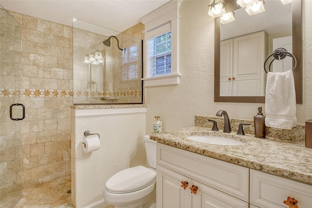 bathroom with vanity, toilet, and a shower with door