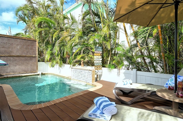 view of swimming pool featuring a wooden deck